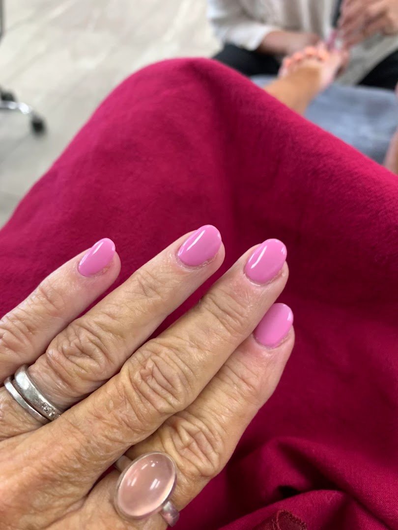 Pink and white acrylic nails on display.